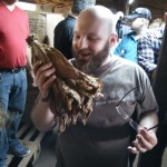 Auston Kleczka smelling a bundle of Criollo tobacco.