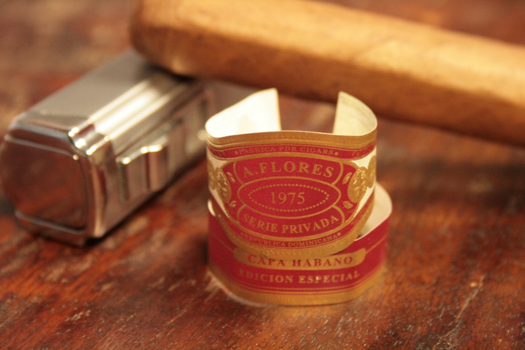 A. Flores 1975 Serie Privada Capa Habano SP52, with band, and lighter.